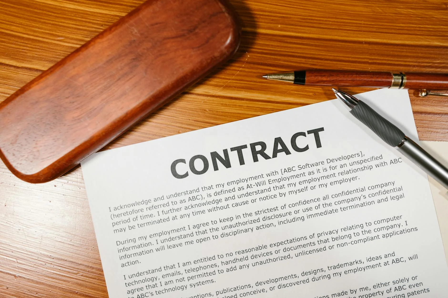 A subcontractor signing a paper conditional waiver of lien form on a clipboard at a construction project office