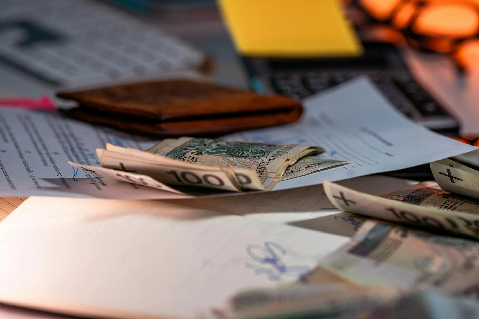 Construction pay application paperwork stacked on a desk, the canonical artifact of the construction pay app workflow