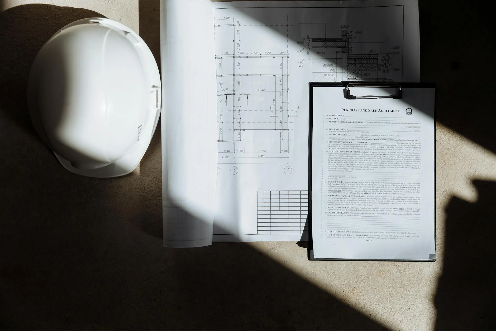 Subcontractor in a hard hat reviewing a lien waiver form on a tablet at a construction site