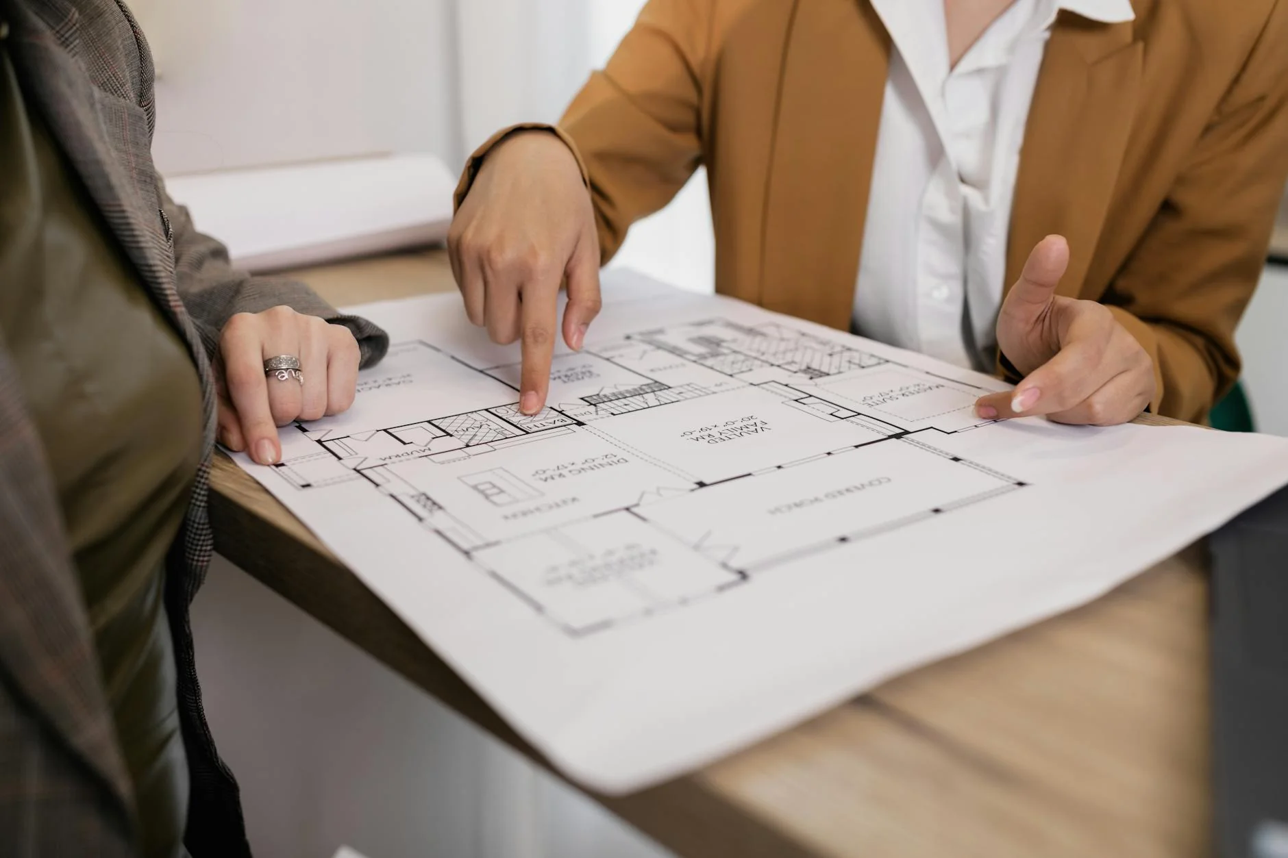 Construction blueprints spread across a table, the visual analogue of how lien release rules vary state by state