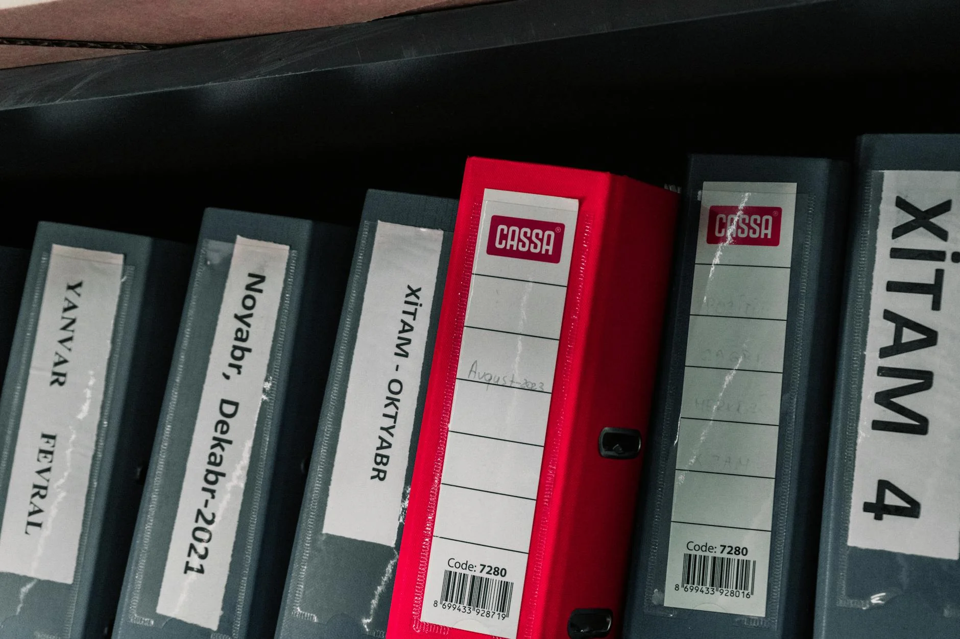 Construction project records and a recorded lien release document on a desk under task lighting
