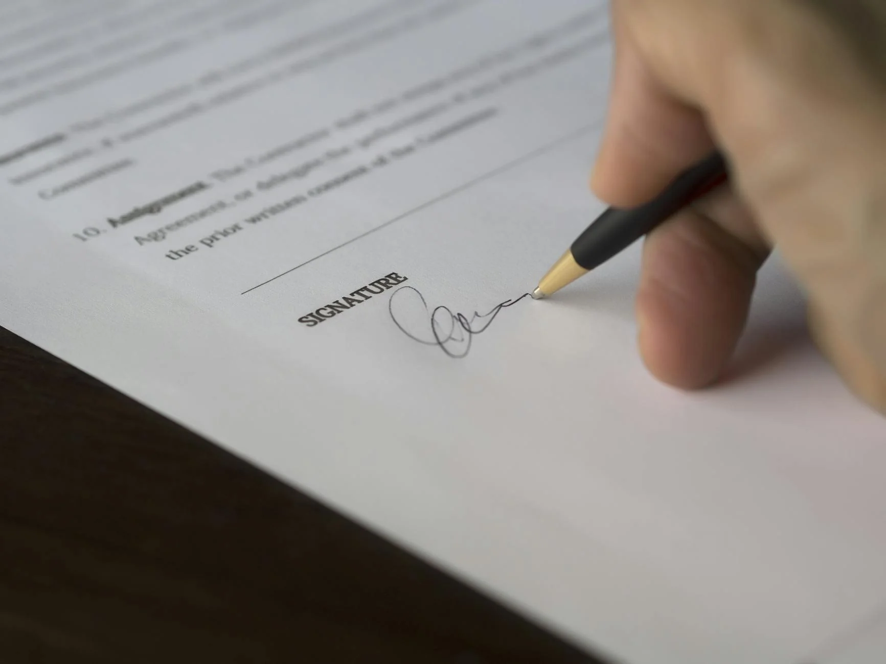 General contractor and subcontractor reviewing a signed contract on a clipboard at a job site